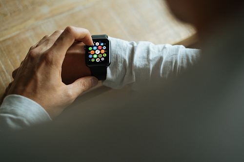 person holding Apple Watch with black Sport Band